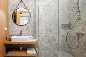 a bathroom with a shower and a sink and a mirror at Eny Guesthouse in Moieciu de Jos +18 photos