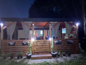 a gazebo at night with lights and plants at Mobile house T&N in Velenje +7 photos