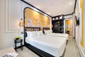 Postel nebo postele na pokoji v ubytování Rokas Hoi An Boutique Hotel