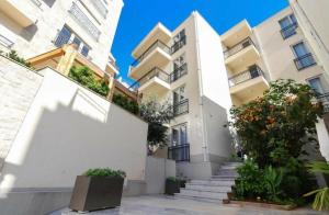 an apartment building with stairs and plants at Studio Prima-Modern Cozy Studio, 4 min to Beach in Pržno