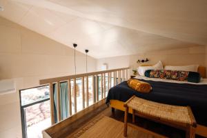 a bedroom with two beds and a balcony at Lahepere Villa mini-villad in Kloogaranna