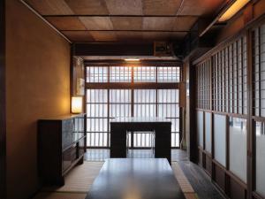 a room with a table in front of a window at Obama Machiya Stay in Obama