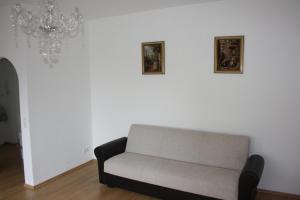 a couch in a living room with two pictures on the wall at Zwei-Zimmer-Wohnung im Zentrum in Dortmund