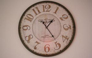 a clock is hanging on a wall at Zwei-Zimmer-Wohnung im Zentrum in Dortmund