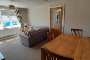 a living room with a couch and a table at Remarkable 2-Bed House in Walesby Nottinghamshire in Elkesley