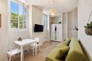a living room with a couch and a table at RIVIERA COZY - Place Massena in Nice