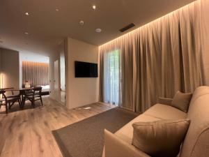 a living room with a couch and a dining room at Evangelisti Palace in Bellaria-Igea Marina