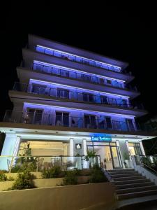 a building with blue lights in front of it at Hotel Parthenon Rodos city in Rhodes Town