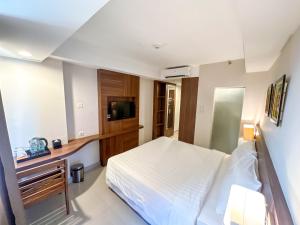 Voodi või voodid majutusasutuse Next Hotel Yogyakarta toas