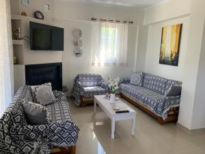 a living room with two couches and a coffee table at Vagias Home in Kanali