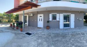 a small house with a porch and a white door at Vagias Home in Kanali
