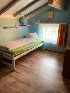 a bedroom with a bed in a room with a window at Duplex Ferienwohnung Edelweiss in Grächen +17 photos