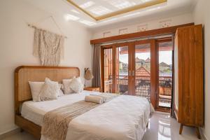 Postel nebo postele na pokoji v ubytování Made Arsa Homestay