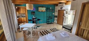 a small kitchen with a table and a bed in a room at House center Licia in Capo dʼOrlando
