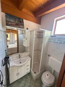 a bathroom with a sink and a shower and a toilet at House center Licia in Capo dʼOrlando +29 photos