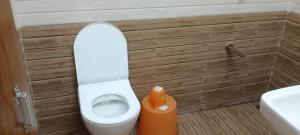 a small bathroom with a toilet and a sink at Hiran Holidays in Sasan Gir
