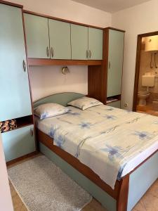 a bedroom with a large bed with a wooden headboard at Apartmani Anđelo, Tommy, Leon in Bibinje +98 photos