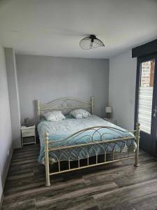 a bedroom with a bed in a room with a window at Chambre d hotes le pigeonnier in Fromelles