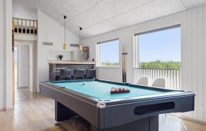 a living room with a pool table in it at 9 Bedroom Lovely Home In Ringkøbing in Søndervig