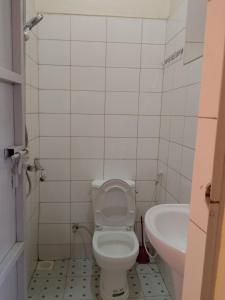 a bathroom with a toilet and a sink at Wana Guest House in Rubirizi