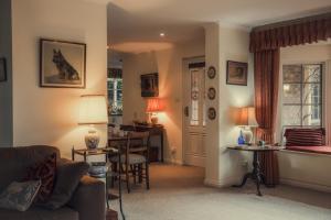 a living room with a couch and a table at Koolyangarra Cottage Adelaide Hills in Adelaide