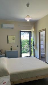 a bedroom with a large bed and a window at La Flacca Rooms in Sperlonga