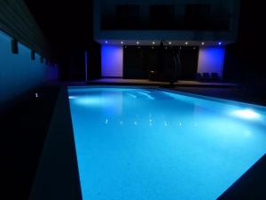 a swimming pool with blue lights in a building at Villa Martina Bellevue in Šmrika
