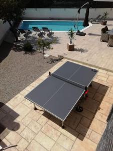 a ping pong table on a patio next to a pool at Villa Martina Bellevue in Šmrika +55 photos