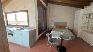 a kitchen with a table and a sink in a room at Loft Catedral con terraza in Segorbe