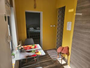 a small room with a table and chairs and a bedroom at Chambre d hotes le pigeonnier in Fromelles +13 photos