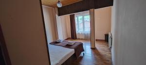 a small room with a bed and a window at Hotel Svanseti in Mestia