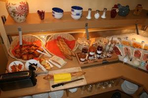 a kitchen counter with a bunch of food on it at Best Hotel Sancé - Mâcon in Mâcon