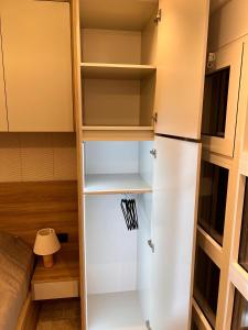 a closet with a white refrigerator in a room at Casa Calma in Bar