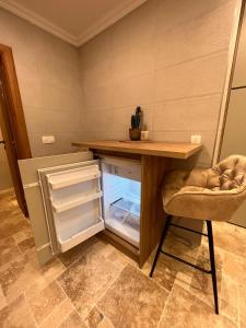 a kitchen with a desk and an open refrigerator at Casa Calma in Bar +7 photos