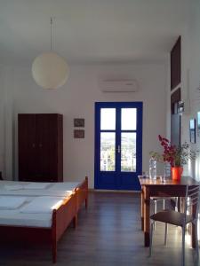 a room with a bed and a table and a window at PanoramaKamil in Kamilari