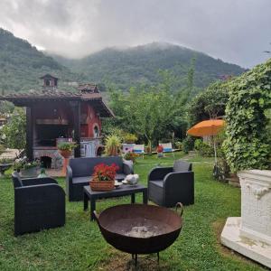 a yard with couches and a table with at jasmine cottage in Luni