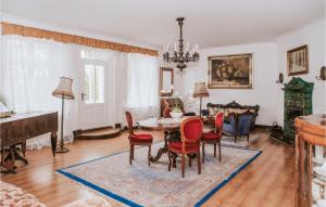 a living room with a table and chairs and a piano at Nice Apartment In Kolobrzeg With Wifi in Kołobrzeg