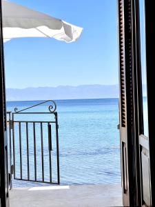 an open door to a view of the ocean at Xenios Zeus Rooms in Koroni