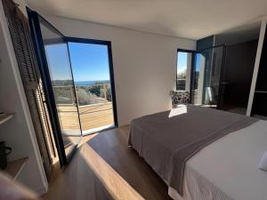 a bedroom with a bed and a large window at Villa Nomade proche de Cannes in Vallauris +35 photos
