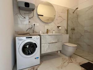 a bathroom with a washing machine and a mirror at Apartman Lavanda in Cres +29 photos