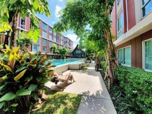 a woman sitting in avisorinylinylinylinylinylinylinylinylinylinyl at Cozy 1-Bedroom in D'vieng Condo in Chiang Mai