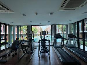 a gym with treadmills and ellipticals in a building at Cozy 1-Bedroom in D'vieng Condo in Chiang Mai