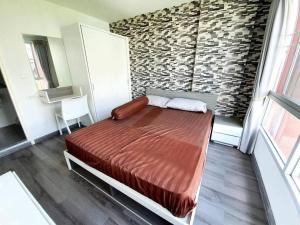 a bedroom with a bed and a brick wall at Cozy 1-Bedroom in D'vieng Condo in Chiang Mai +19 photos