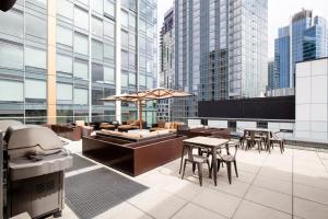 a rooftop patio with tables and chairs on a building at Downtown Studio w Gym WD walkable location SEA-47 in Seattle