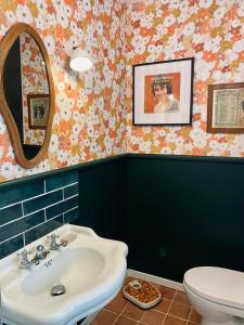 a bathroom with a sink and a toilet at Maison La folie douce in Saint-Pierre-de-Manneville