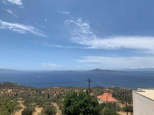 a view of the ocean from a house at Heavenly View Peach in Lákhion