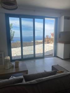 a living room with a view of the ocean at Heavenly View Peach in Lákhion