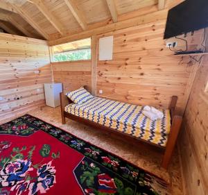 a room with a bed in a log cabin at Visit Plav in Plav