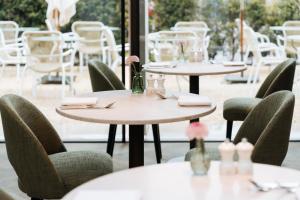 a row of tables and chairs in a restaurant at De Tuilerieën - Small Luxury Hotels of the World in Bruges