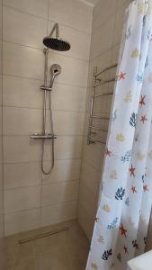 a bathroom with a shower with a shower curtain at Pokoje na plaży in Ustronie Morskie